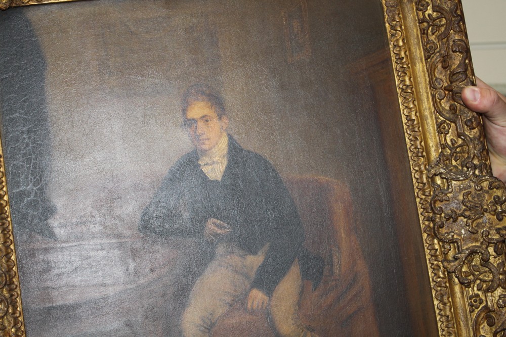 Early 19th century English School, oil on canvas, Full length portrait of a gentleman seated beside a writing slope, 53 x 40cm